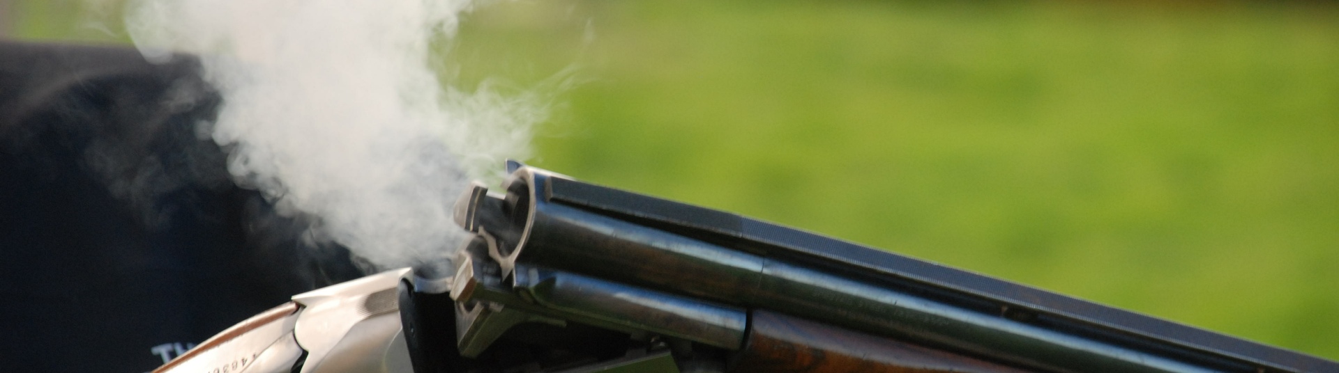 Flightline Sporting shotgun breaking releasing smoke Flightline Sporting shotgun breaking releasing smoke
