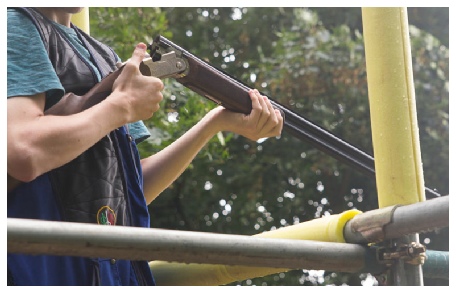 Flightline sporting image of a man loading a shotgun Flightline sporting image of a man loading a shotgun